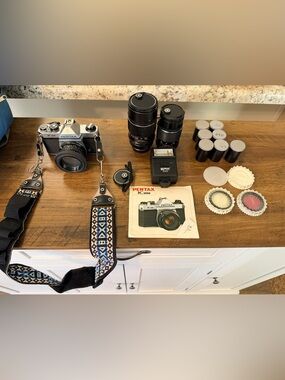 Pentax Film Camera Accessories with Black Bodies and Blue Patterned Strap